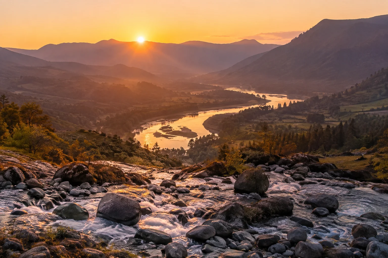 A river bending through a valley over smooth stones at sunrise